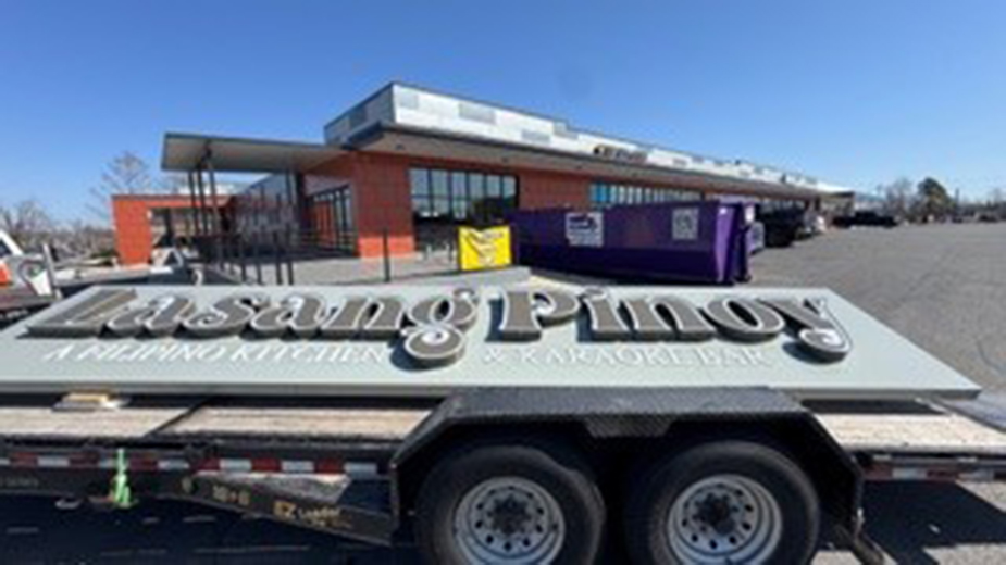 Image of the Lasang Pinoy building signage before installation, featured in a pre-opening article by the Rogers-Lowell Chamber.